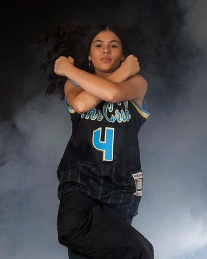 Person wearing a The Crib jersey with number 4 in a smoky setting