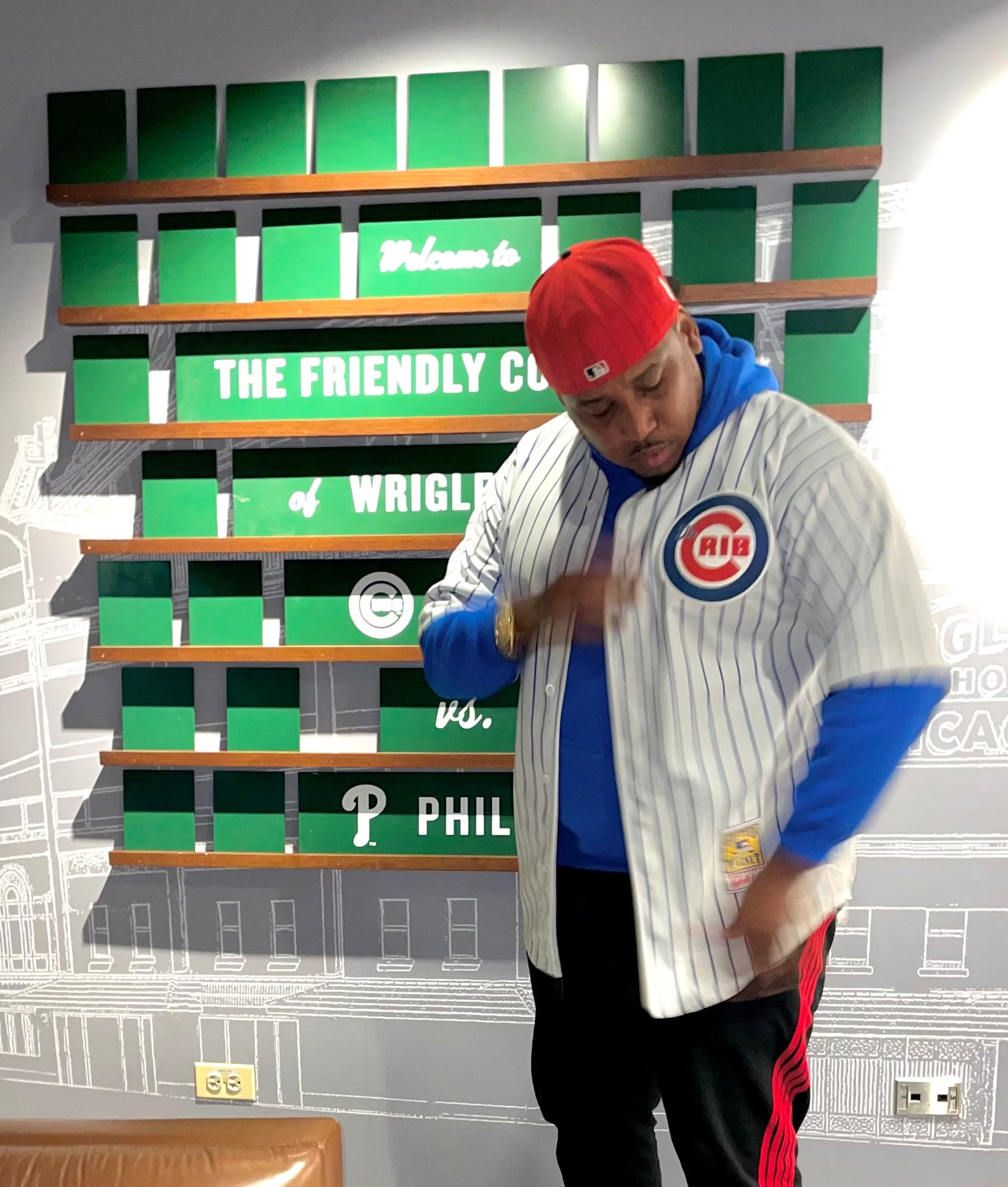 Person wearing a Chicago The Crib jersey in a room with sports-themed decor